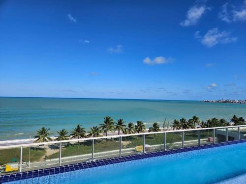a view of the ocean from the balcony of a resort at Micro estúdio Intermares- Cabedelo/PB in Cabedelo