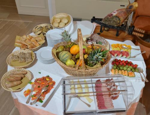 a table topped with lots of different types of food at Hotel Settentrionale Esplanade in Montecatini Terme