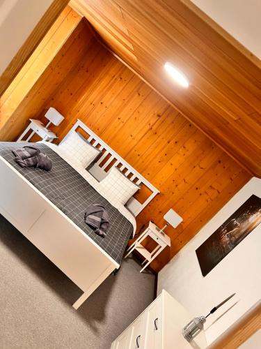 a room with a bed and a wooden ceiling at AFA1 in Göschenen