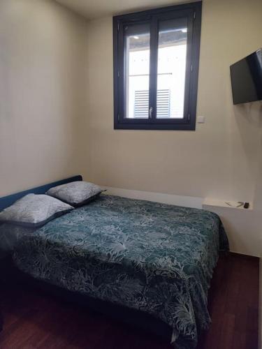 une chambre avec un lit et une fenêtre dans l'établissement Loft Paris centre face au parc des buttes Chaumont, à Paris