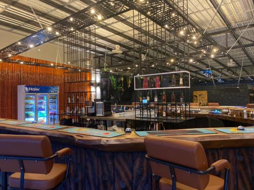 a bar in a restaurant with a large wooden counter at Hideaway Resort Banchang in Ban Chang