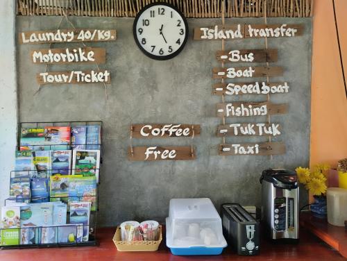 a wall with a clock and signs on it at Zabit Bungalow in Ko Lanta