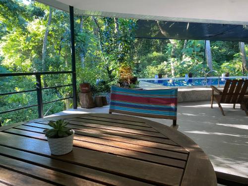 a wooden table and bench on a patio at Balai Benedicere Bed & Breakfast in Bacnotan