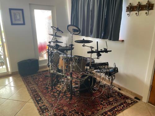 a room with a drum set sitting on a rug at Pau Hana Paradise in Hana