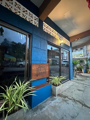 a restaurant with a sign on the side of a building at THADAN GUEST HOUSE in Ban Houayxay
