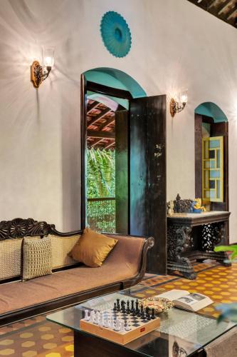 a living room with a couch and a chess board at Villa Sereno by Insignia Villas in Assagao