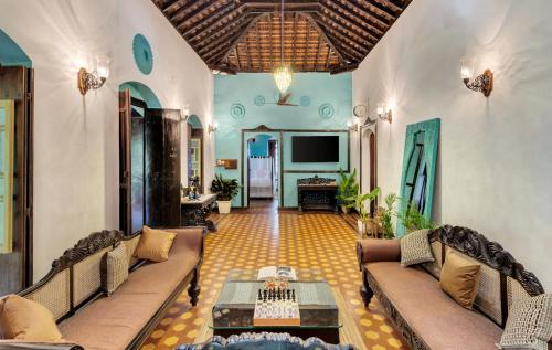 a living room with two couches and a tv at Villa Sereno by Insignia Villas in Assagao