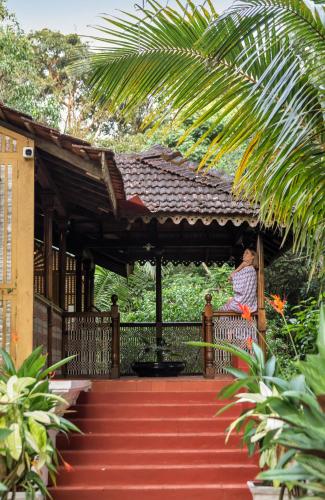 a person sitting on a porch of a house at Villa Sereno by Insignia Villas in Assagao
