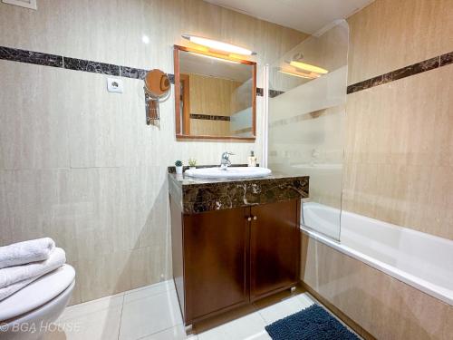 a bathroom with a sink and a toilet and a tub at Bga Rentals Garbi in Cambrils