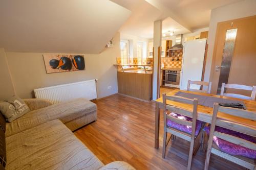 a living room and kitchen with a table and a couch at Pension Tibor a Luna in Cerny Dul
