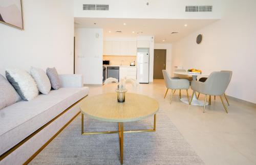 a living room with a couch and a table at CitiHome-1BR Large Living Room Ideal for Small Families in Dubai