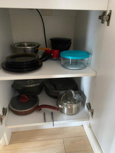 a cabinet filled with pots and pans and plates at SaBa Apartments in Old Tbilisi in Tbilisi City