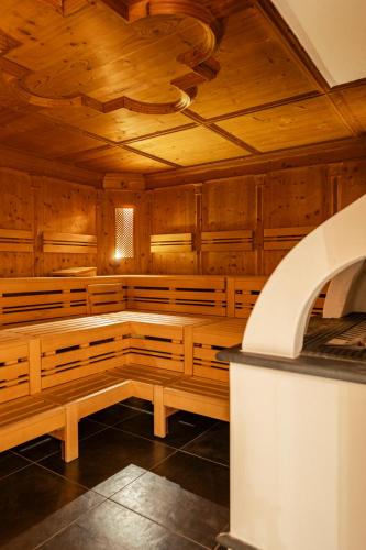 an empty sauna with wooden walls and a ceiling at DAS BADL - Smart Retreat AO in Caldaro