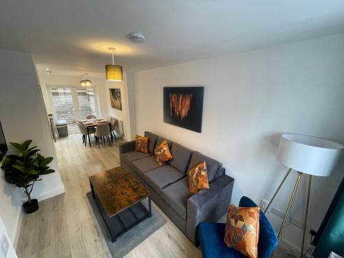 a living room with a couch and a table at 3 Bedroom New House with Wi-Fi Sleep 5 By Home Away From Home - A in Newcastle under Lyme