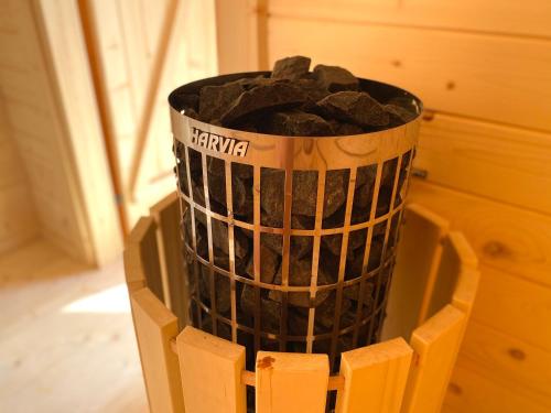 a trash can filled with rocks in a wooden crate at Jurkowa Wola in Jureczkowa
