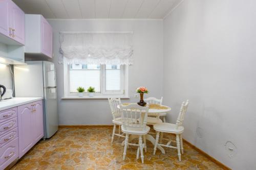 a kitchen with a table and chairs and a window at Vanemuise apartment in Tartu