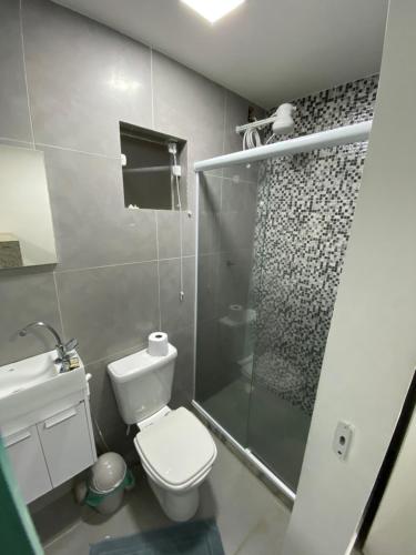 a bathroom with a toilet and a glass shower at Suite Vargem Grande 2 - praia, cachoeira e trilhas in Rio de Janeiro