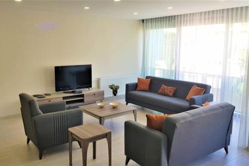 a living room with two couches and a tv at 10 Central Location, Close To Beaches And Anywhere in Antalya