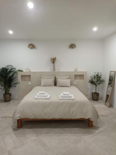 une chambre avec un grand lit avec deux serviettes dessus dans l'établissement La Suite du clocher, à Noves