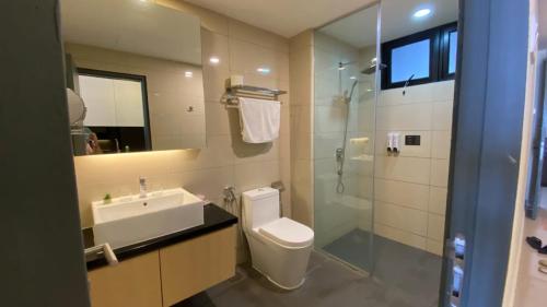 a bathroom with a toilet and a sink and a shower at Hilltop Cloud View Genting Luxury Suite in Genting Highlands