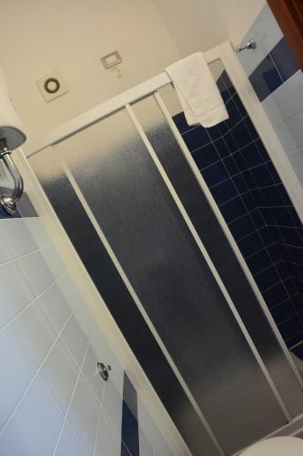 a shower with a glass door in a bathroom at B&B La Casa Rossa in Paola