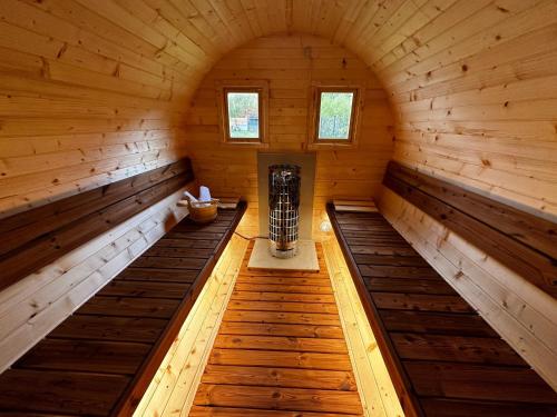 an inside view of a wooden cabin with two benches at Apartmány U Rodinky in Lipova Lazne