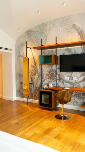 a room with a bed and a table and a chair at Palazzo Martinelli in Sorrento