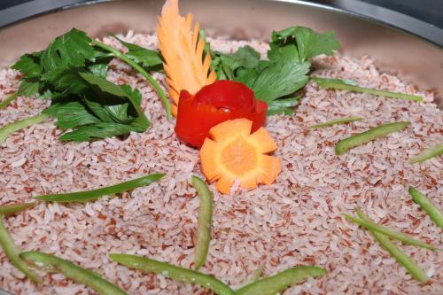a pot filled with rice and vegetables on top at Miracle Resorts & Villas in Polonnaruwa