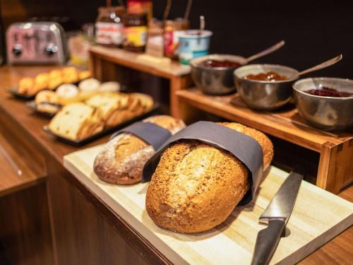 a bunch of loaves of bread sitting on a counter at ibis Gent Centrum Opera in Ghent