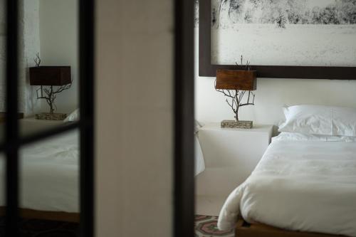 a bedroom with a bed and two lamps on a table at AL PALAZZO La Dimora by Apulia Hospitality in Fasano