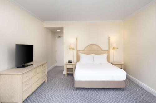 a bedroom with a bed and a flat screen tv at Hilton Northampton Hotel in Northampton