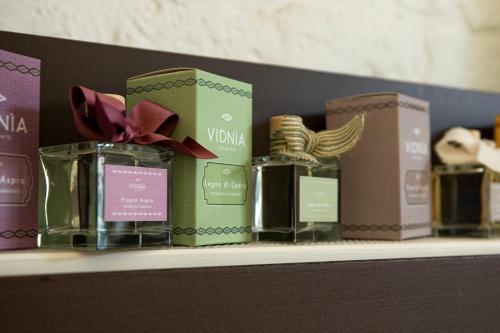 a shelf with several glass jars and boxes on it at AL PALAZZO La Dimora by Apulia Hospitality in Fasano