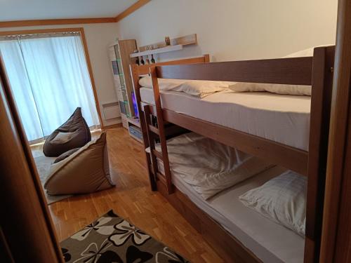 two bunk beds in a room with a window at Snježna Vila in Jahorina
