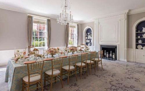 a large dining room with a long table with chairs at The Carolina Inn, a Destination by Hyatt Hotel in Chapel Hill