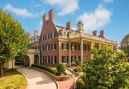 a large brick building with turrets at The Carolina Inn, a Destination by Hyatt Hotel in Chapel Hill