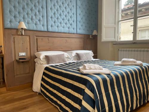 a bedroom with a bed with two towels on it at Chalet Lucca in Lucca