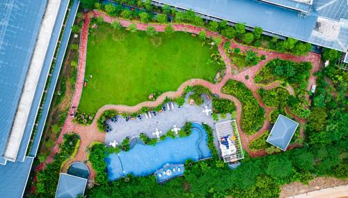 an overhead view of a garden with a swimming pool at Mayfair Oasis Resort & Convention in Jhārsuguda