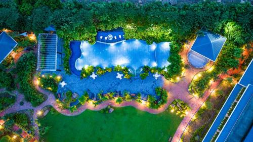 an aerial view of a swimming pool in a garden at Mayfair Oasis Resort & Convention in Jhārsuguda