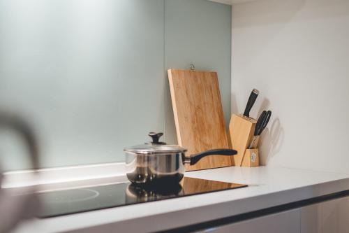 a pot sitting on top of a stove in a kitchen at Teega Muji 4BR 12 pax w bathtub by Our Stay in Nusajaya