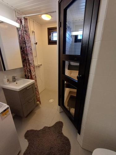 a bathroom with a sink and a toilet and a mirror at Pikiruukin kruunu in Kokkola