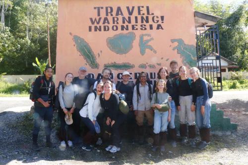 a group of people standing in front of a sign at Cinta alam inn in Kutacane