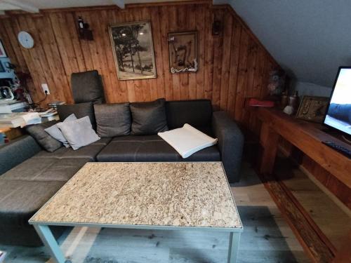 a living room with a couch and a table at Wohnung am Wanderweg zum Königsstuhl unter Reet in Lohme