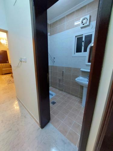 a bathroom with a shower and a toilet and a sink at شقة واسعة غرفتين نوم وصالة in Tabuk