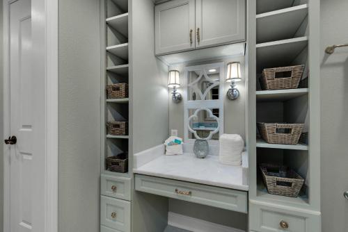 a walk in closet with white cabinets and a sink at Portofino Island Resort 4-1305 in Pensacola Beach