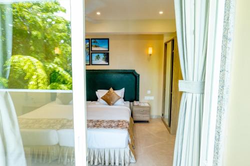 a bedroom with a bed and a window at Hotel Flora Inn Male Maldives in Male City