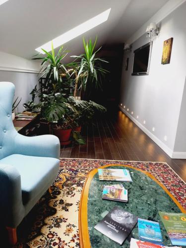 a living room with a couch and potted plants at Varga Villa in Orfű