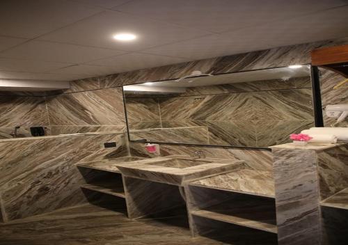a bathroom with two sinks and a large mirror at CLUB 21 by Sariska Fun City, Alwar in Mācheri