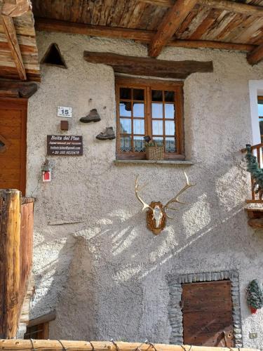 a building with a antler on the side of it at Baita del Plan in Pragelato