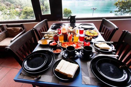 a table with plates of food on it at Manu Maharani Regency in Nainital