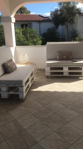 a patio with two couches sitting on a patio at Via Genova 1480 in San Teodoro